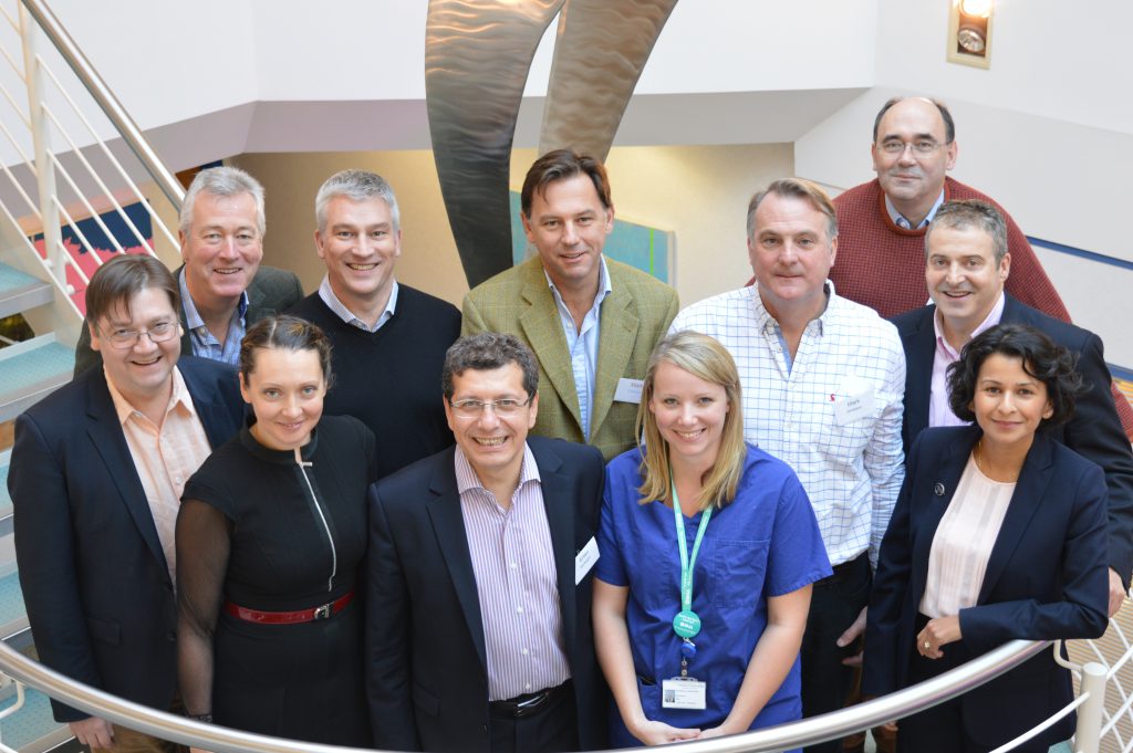 Group of people smiling on staircase.